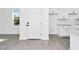 Bright entryway and open kitchen featuring granite countertops, white cabinetry and stainless steel appliances at 1022 Mack Ave, Orlando, FL 32805