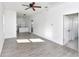 Open concept living room featuring tile floors, ceiling fan, and access to kitchen at 1022 Mack Ave, Orlando, FL 32805