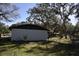 House exterior and fenced backyard with large trees at 1080 Springbank Ave, Orange City, FL 32763