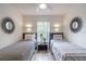 Two twin beds, window, and modern decor at 1118 Park Ridge Cir, Kissimmee, FL 34746