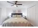 Main bedroom with a king-size bed, ceiling fan, and ample closet space at 1118 Park Ridge Cir, Kissimmee, FL 34746
