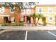 Front view of a three-unit townhome building with parking at 1118 Park Ridge Cir, Kissimmee, FL 34746