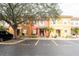 Exterior view showing three townhouses, landscaping, and parking at 1118 Park Ridge Cir, Kissimmee, FL 34746