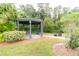 Wooden gazebo with seating, surrounded by landscaping at 1118 Park Ridge Cir, Kissimmee, FL 34746