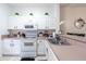 Modern kitchen boasts white cabinets, stainless steel appliances, and a breakfast bar at 1118 Park Ridge Cir, Kissimmee, FL 34746