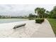 Sandy lakeside path with a bench and palm trees at 1118 Park Ridge Cir, Kissimmee, FL 34746