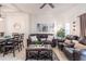 Open living area with leather couches, a dining table, and a ceiling fan at 1118 Park Ridge Cir, Kissimmee, FL 34746