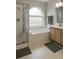 Modern bathroom with shower, bathtub, and vanity with lots of natural light at 12212 Holly Jane Ct, Orlando, FL 32824
