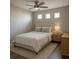 Cozy bedroom featuring a ceiling fan and a trio of small windows allowing ample natural light at 12212 Holly Jane Ct, Orlando, FL 32824
