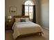Comfortable bedroom featuring a large arched window and neutral decor creating a relaxing atmosphere at 12212 Holly Jane Ct, Orlando, FL 32824