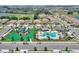 Aerial view of community pool, playground, and homes at 1320 Moss Creek Ln, Davenport, FL 33836
