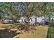 Landscaped backyard with a large tree, grassy area, and privacy fence at 1320 Moss Creek Ln, Davenport, FL 33836