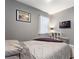Bedroom with gray walls and striped bedding at 1320 Moss Creek Ln, Davenport, FL 33836