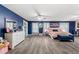 Main bedroom with plush bed, dresser, and a blue accent wall at 1320 Moss Creek Ln, Davenport, FL 33836