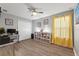 Home office with wood floors, built-in shelving, and window with yellow curtains at 1320 Moss Creek Ln, Davenport, FL 33836