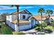 Two-story home with tile roof, white exterior, and a two-car garage at 1320 Moss Creek Ln, Davenport, FL 33836