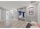 Bright hallway featuring two large framed pictures and access to bedrooms at 1320 Moss Creek Ln, Davenport, FL 33836