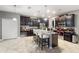 Spacious kitchen featuring dark wood cabinets, granite island, and breakfast bar at 1320 Moss Creek Ln, Davenport, FL 33836