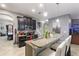 Eat-in kitchen with breakfast bar, stainless steel appliances, and granite countertops at 1320 Moss Creek Ln, Davenport, FL 33836