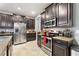 Kitchen with dark wood cabinets and stainless steel appliances at 1320 Moss Creek Ln, Davenport, FL 33836
