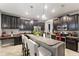 Modern kitchen with granite countertops, dark cabinets, and stainless steel appliances at 1320 Moss Creek Ln, Davenport, FL 33836