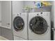 Laundry room with side-by-side Electrolux washer and dryer at 1320 Moss Creek Ln, Davenport, FL 33836