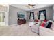 Relaxing living room featuring a large sectional sofa and flat-screen TV at 1320 Moss Creek Ln, Davenport, FL 33836
