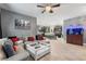 Spacious living room with sectional sofa, coffee table, and views into the kitchen at 1320 Moss Creek Ln, Davenport, FL 33836