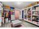 Spacious walk-in closet with custom shelving and hanging rods at 1320 Moss Creek Ln, Davenport, FL 33836