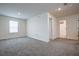 Expansive bedroom showcases neutral walls and carpet, window, and doorway to the private ensuite bathroom at 1765 Petiole Pl, Kissimmee, FL 34744