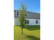 The backyard features a lush green lawn and sliding glass doors leading to the home at 196 Albany Dr, Kissimmee, FL 34759