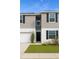 Charming two-story home featuring a well-manicured lawn and attached garage at 196 Albany Dr, Kissimmee, FL 34759