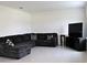 Spacious living room featuring a large sectional sofa and flat-screen TV at 196 Albany Dr, Kissimmee, FL 34759
