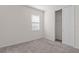 Bright bedroom with neutral walls and carpet, featuring a large window and closet at 2124 Live Oak Lake Rd, St Cloud, FL 34771