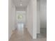 Long hallway with tile floors and neutral-toned walls at 2124 Live Oak Lake Rd, St Cloud, FL 34771