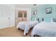 Charming bedroom with twin beds, light teal walls, and access to upstairs loft at 2243 Wyndham Palms Way, Kissimmee, FL 34747