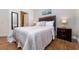 Cozy bedroom with double bed, nightstand, and adjacent bathroom at 2243 Wyndham Palms Way, Kissimmee, FL 34747