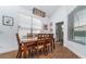 Bright dining room with wood table and chairs, adjacent half-bath, and view of pool at 2243 Wyndham Palms Way, Kissimmee, FL 34747