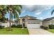 Attractive two-story house with a two-car garage and lush landscaping at 2243 Wyndham Palms Way, Kissimmee, FL 34747