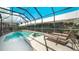 Relaxing screened pool and spa with lounge chairs at 2243 Wyndham Palms Way, Kissimmee, FL 34747