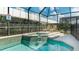 Inviting screened pool and spa with lounge chairs at 2243 Wyndham Palms Way, Kissimmee, FL 34747