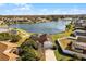 Aerial view of house near lake with pool and large backyard at 2302 Aberdeen Ct, Kissimmee, FL 34743