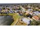 Aerial view of house near lake with pool and fenced backyard at 2302 Aberdeen Ct, Kissimmee, FL 34743