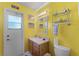 Bright yellow bathroom with vanity and toilet at 2302 Aberdeen Ct, Kissimmee, FL 34743