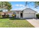 Single-story home with attached garage and well-maintained lawn at 2302 Aberdeen Ct, Kissimmee, FL 34743