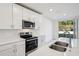 Modern kitchen with stainless steel appliances and white cabinets at 2315 White Tail St, Davenport, FL 33837