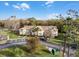 Aerial view of a charming apartment community with lush landscaping at 2452 Sweetwater Club Cir # 27, Kissimmee, FL 34746