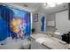 Bathroom with a tub, shower, and Mickey Mouse themed decor at 2452 Sweetwater Club Cir # 27, Kissimmee, FL 34746