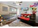 Bedroom with bunk beds, red couch, and Mickey Mouse themed wall art at 2452 Sweetwater Club Cir # 27, Kissimmee, FL 34746