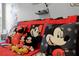 Mickey Mouse themed pillows and plush toys on a red couch at 2452 Sweetwater Club Cir # 27, Kissimmee, FL 34746